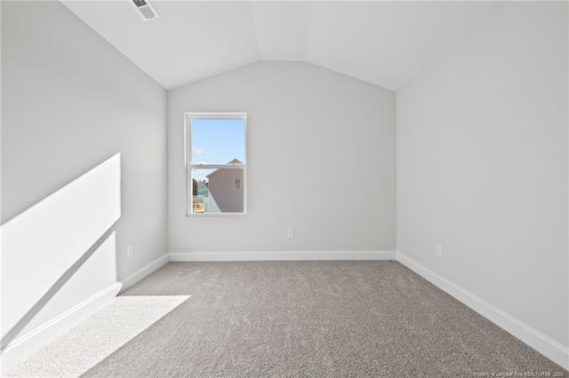 interior space with light colored carpet and vaulted ceiling