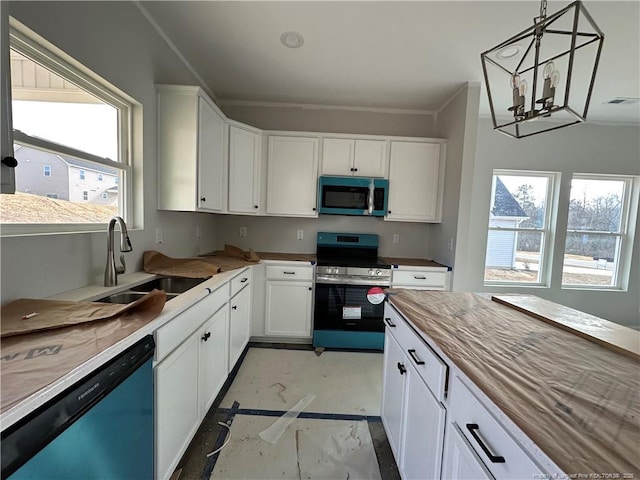 kitchen featuring stainless steel appliances, hanging light fixtures, sink, and white cabinets