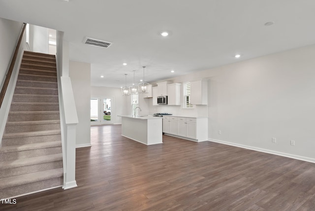 unfurnished living room featuring dark hardwood / wood-style flooring and sink