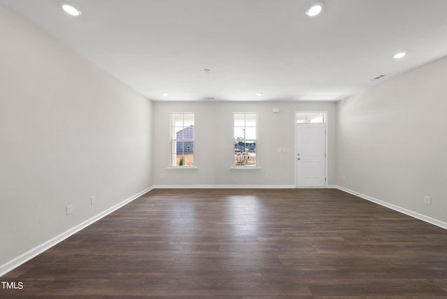 unfurnished room with dark hardwood / wood-style flooring