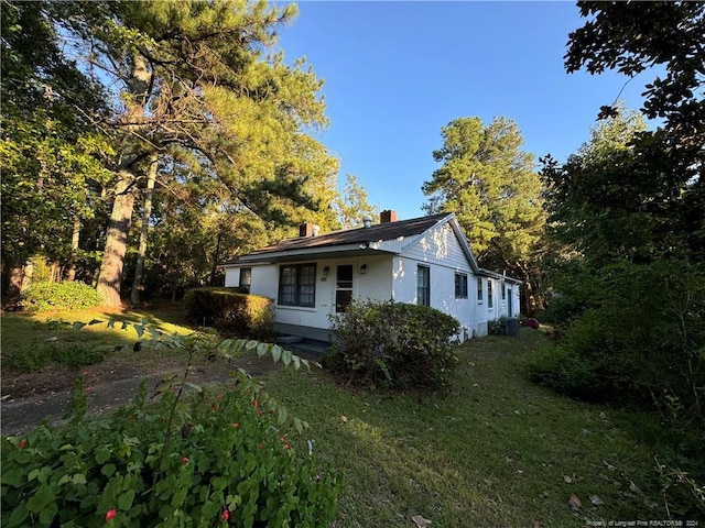 view of home's exterior with a lawn