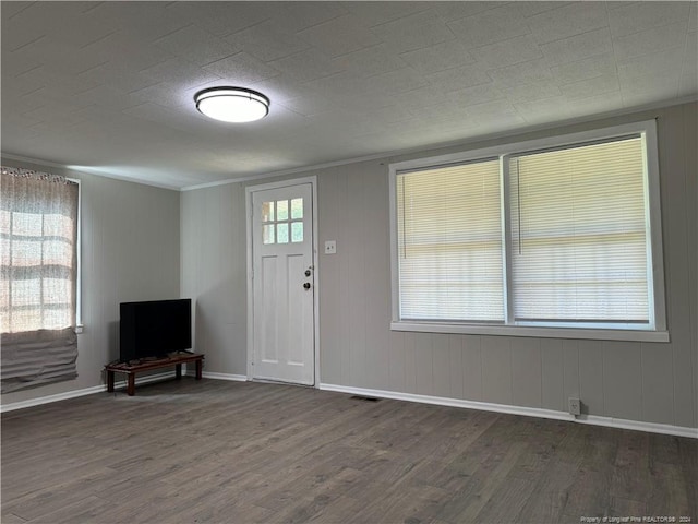 foyer with baseboards, wood finished floors, and plenty of natural light