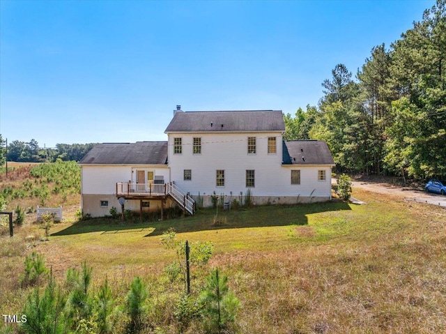 back of property featuring a yard and a wooden deck