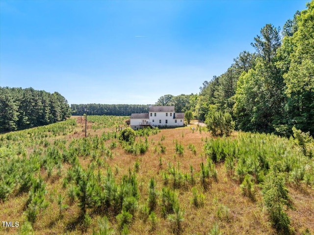 birds eye view of property with a rural view