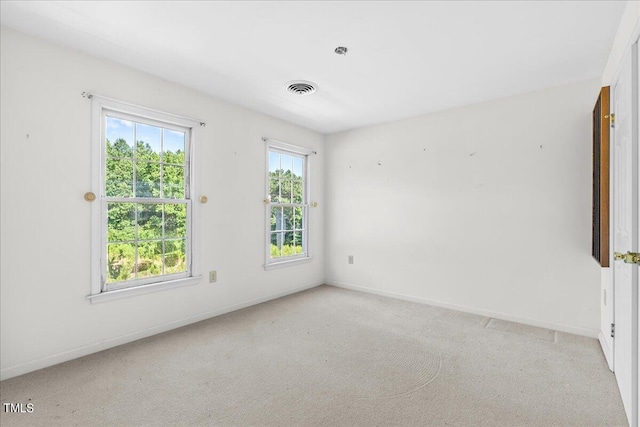 spare room with light colored carpet