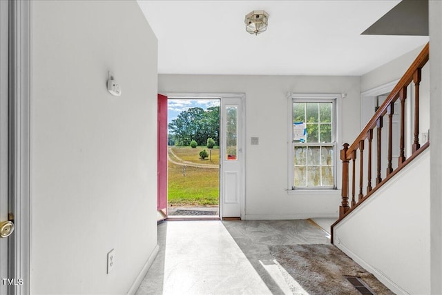 entrance foyer with light colored carpet