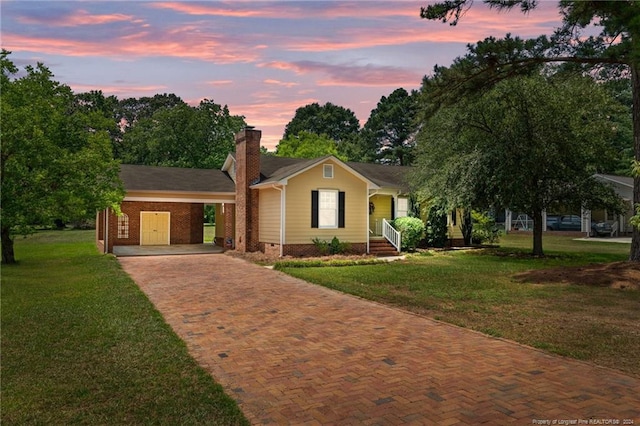 ranch-style home with a yard and a carport