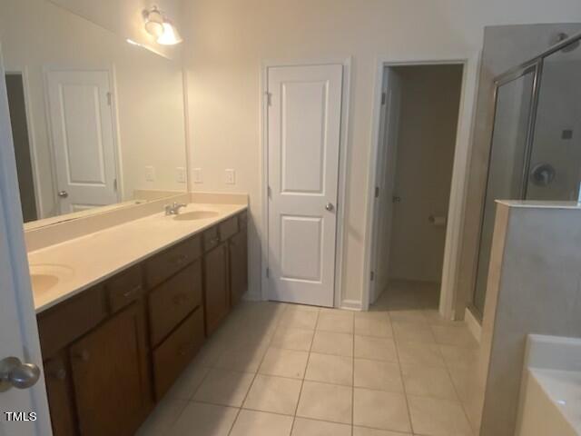 bathroom featuring shower with separate bathtub, tile patterned flooring, and dual bowl vanity