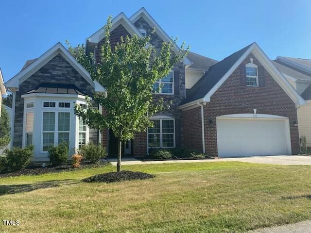 view of front of property with a garage and a front lawn