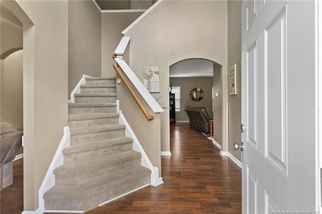 entryway with a high ceiling and dark hardwood / wood-style floors