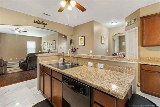 kitchen featuring light wood-type flooring, ceiling fan, sink, a center island with sink, and dishwasher