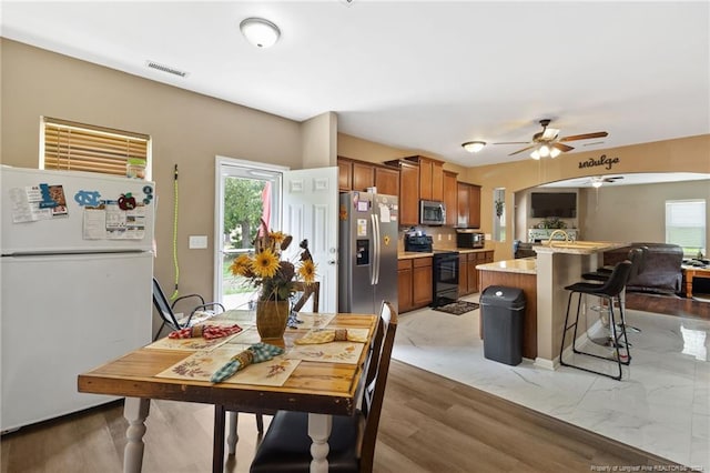 dining space featuring ceiling fan, plenty of natural light, and hardwood / wood-style floors