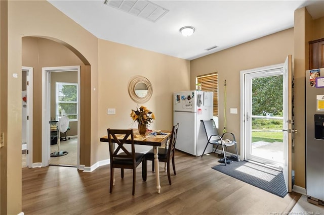 dining space with dark hardwood / wood-style flooring