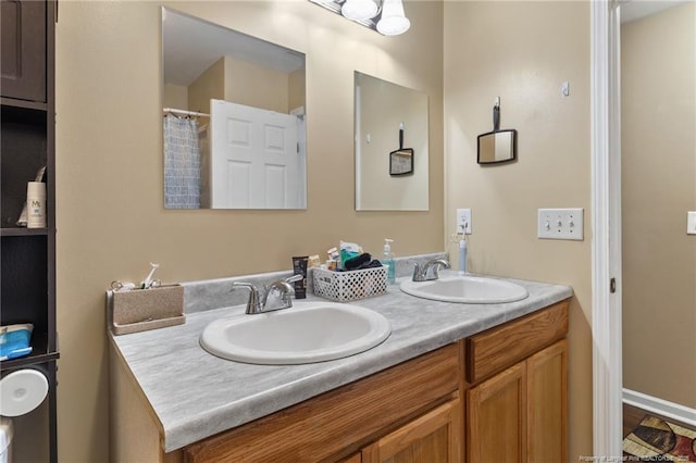 full bathroom featuring double vanity and a sink