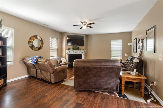 living area with plenty of natural light, a fireplace, dark wood finished floors, and baseboards