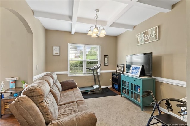 living area with a chandelier, arched walkways, coffered ceiling, baseboards, and beam ceiling