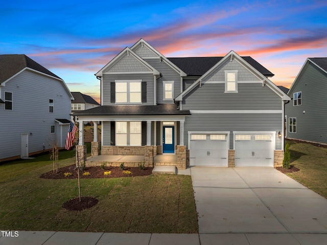 craftsman-style house with a lawn and a garage