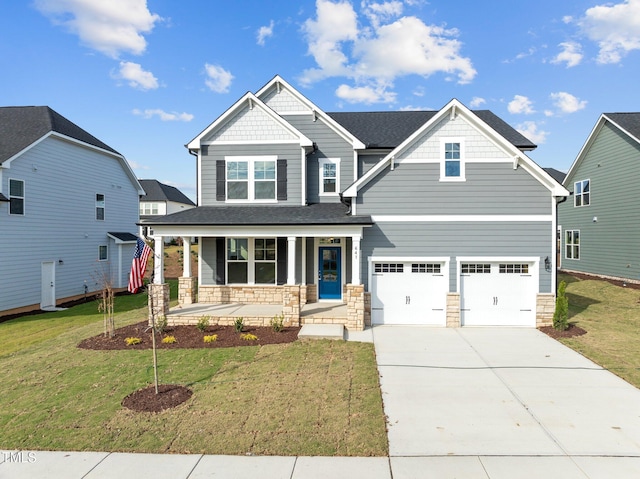 craftsman inspired home with a porch, a garage, and a front lawn