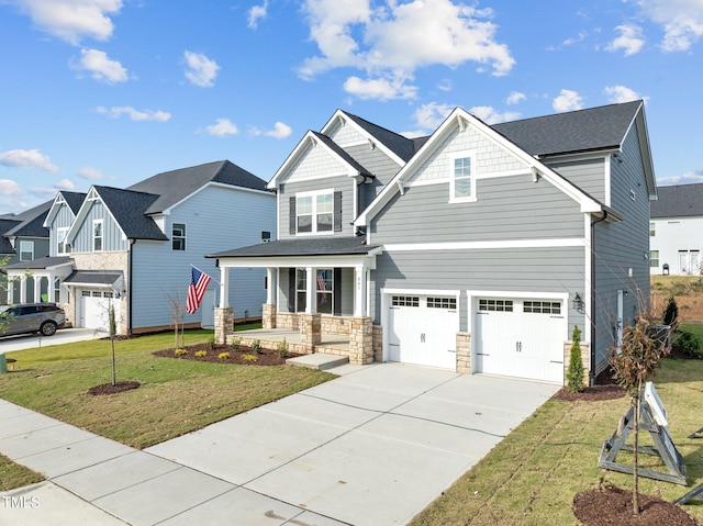 craftsman inspired home featuring a front yard, a porch, and a garage