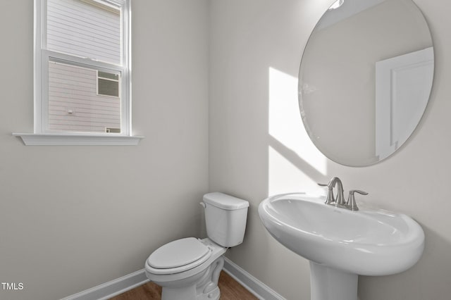 bathroom featuring hardwood / wood-style floors, toilet, and sink