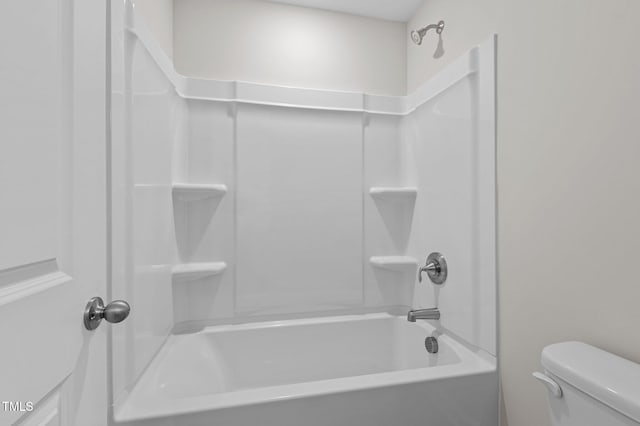 bathroom with washtub / shower combination and toilet