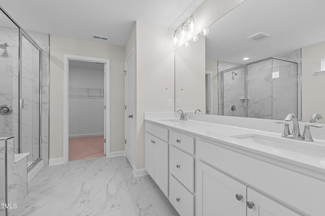 bathroom with vanity and a shower with door