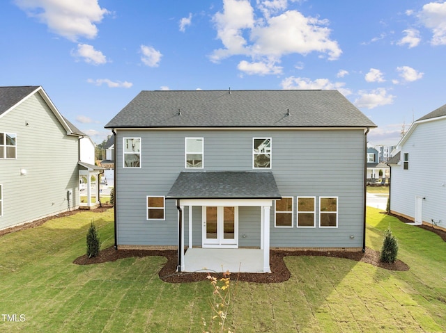 back of property with a patio and a lawn