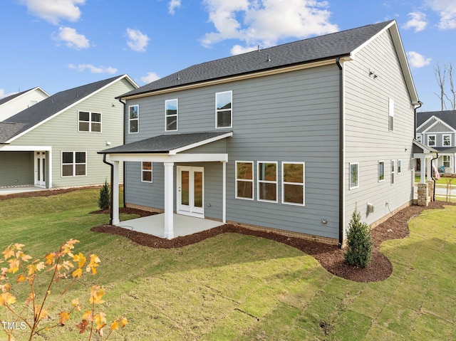 rear view of property with a yard and a patio area