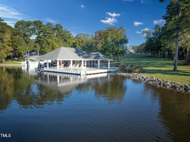 view of dock featuring a water view and a lawn