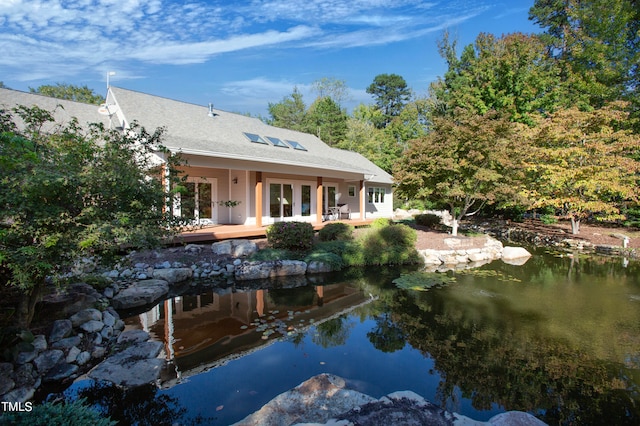 rear view of property featuring a water view