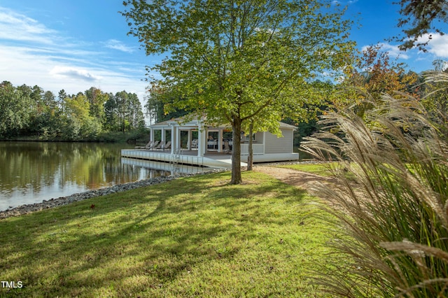 dock area featuring a water view and a lawn