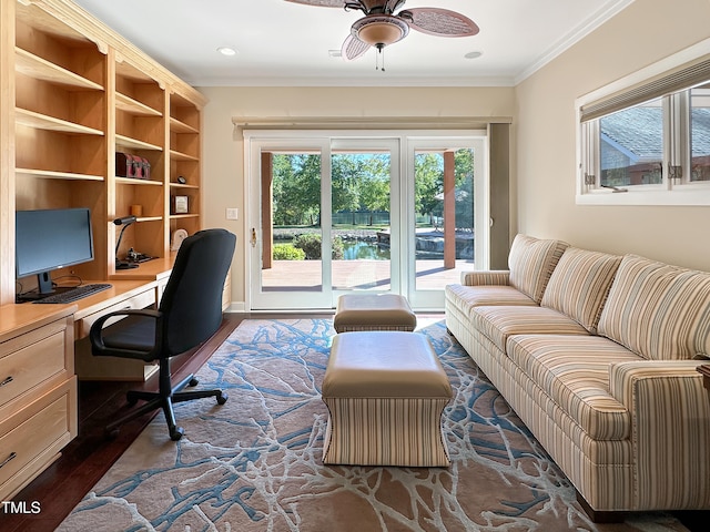 office area with dark hardwood / wood-style flooring, ceiling fan, built in desk, and ornamental molding