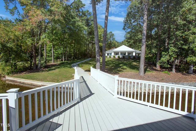 wooden deck featuring a yard and a gazebo