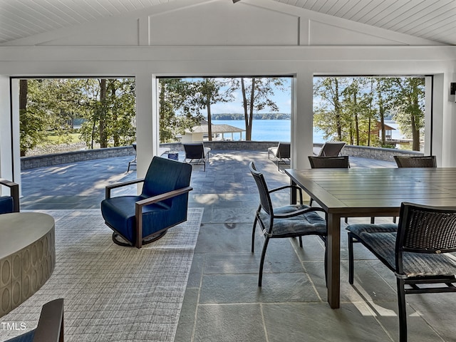 sunroom / solarium with a water view and lofted ceiling