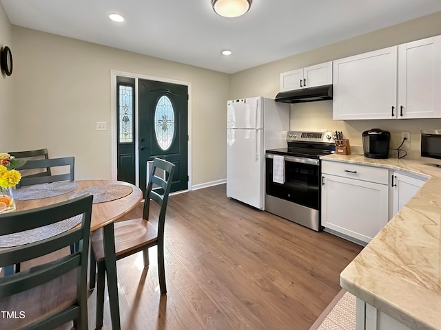 kitchen featuring stainless steel appliances, wood-type flooring, and white cabinetry