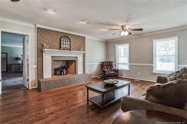 living room featuring a textured ceiling, a brick fireplace, dark wood-type flooring, ceiling fan, and ornamental molding