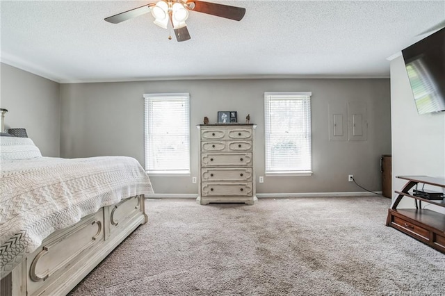 bedroom featuring a textured ceiling, carpet floors, and ceiling fan