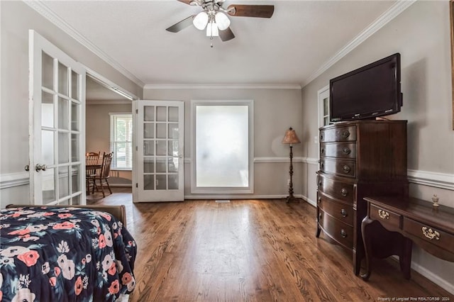 bedroom featuring crown molding, french doors, hardwood / wood-style floors, and ceiling fan