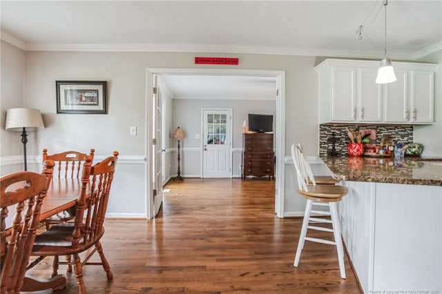 dining room featuring ornamental molding and hardwood / wood-style flooring