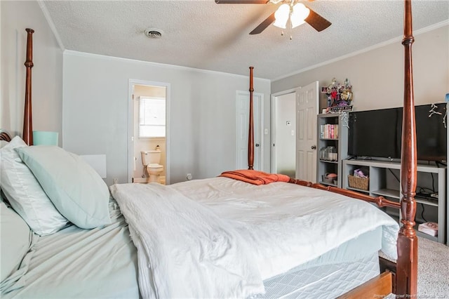 bedroom with a textured ceiling, ornamental molding, ensuite bath, and ceiling fan