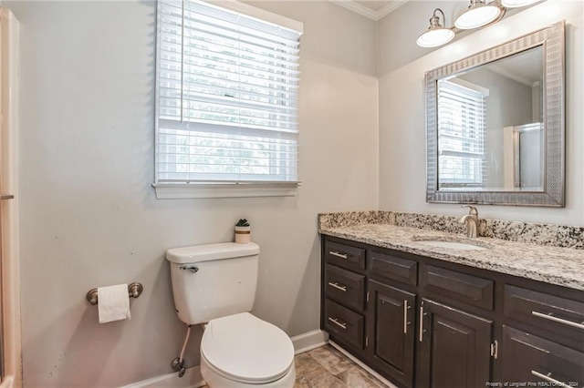 bathroom featuring tile patterned floors, vanity, crown molding, and toilet