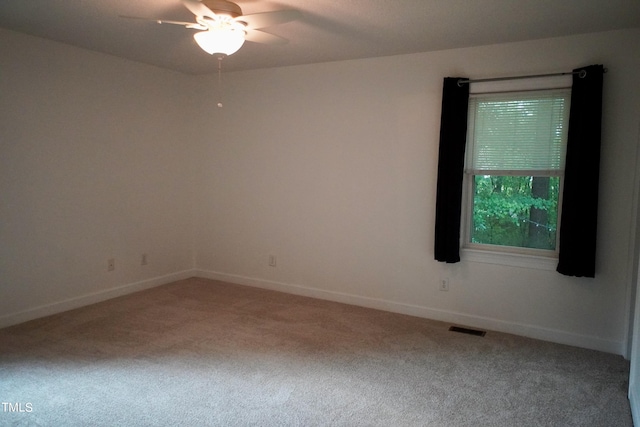 empty room with ceiling fan and carpet