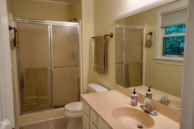 bathroom with vanity, an enclosed shower, tile patterned floors, crown molding, and toilet