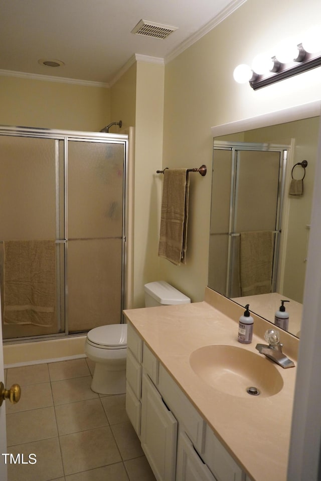 bathroom with toilet, crown molding, tile patterned floors, a shower with door, and vanity