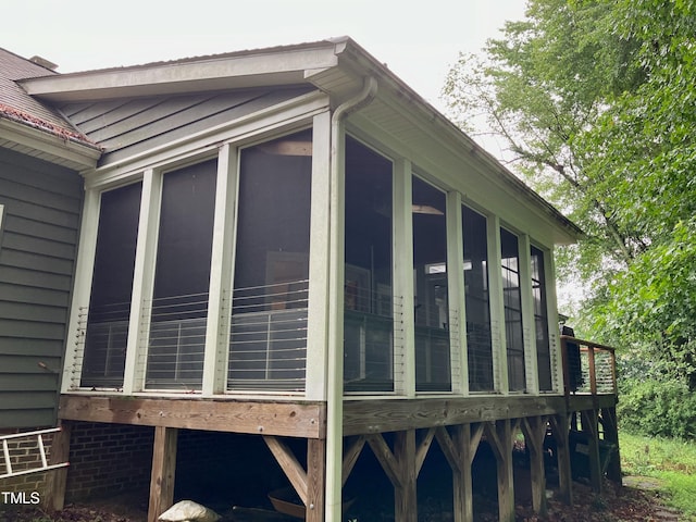 view of property exterior featuring a sunroom