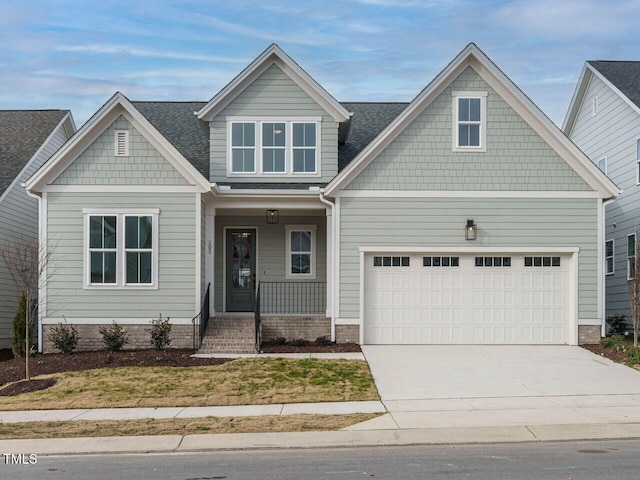 craftsman inspired home with a front lawn, a porch, and a garage