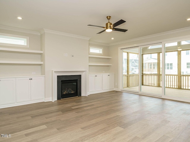205 Wash Hollow Dr, Wendell, NC 27591 - unfurnished living room with built in shelves, ornamental molding, and light wood-type flooring