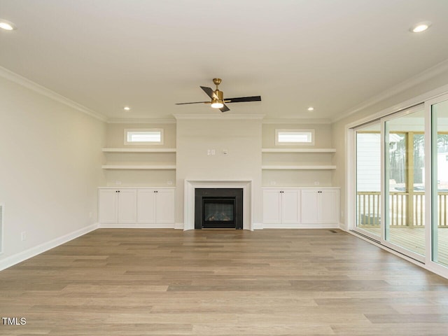 205 Wash Hollow Dr, Wendell, NC 27591 - unfurnished living room featuring built in shelves, ornamental molding, and light hardwood / wood-style flooring