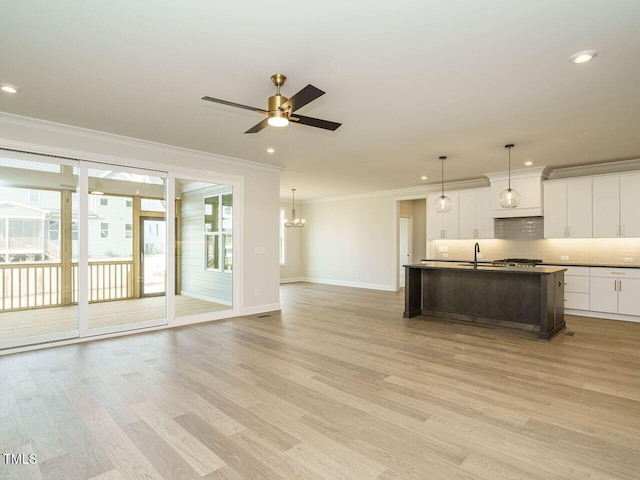 205 Wash Hollow Dr, Wendell, NC 27591 - kitchen with decorative light fixtures, ornamental molding, an island with sink, white cabinets, and backsplash