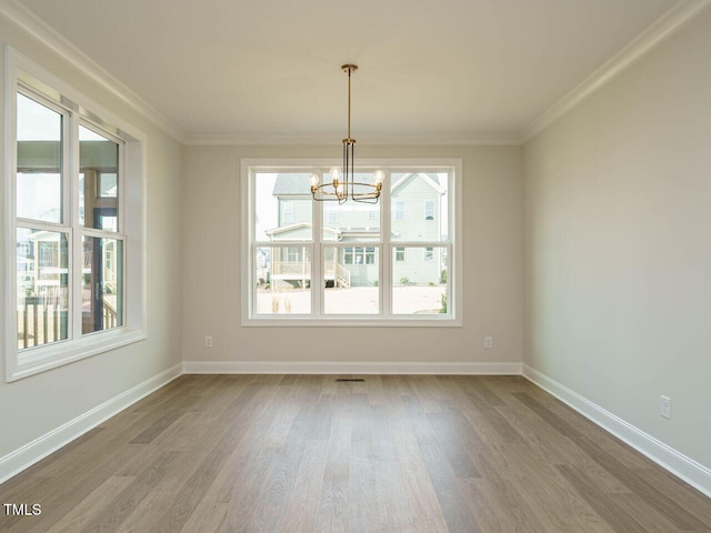205 Wash Hollow Dr, Wendell, NC 27591 - unfurnished dining area featuring hardwood / wood-style flooring, ornamental molding, and a wealth of natural light
